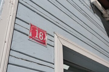 house number. Decorative lettering on a brick wall.