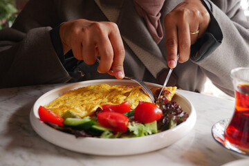 eating Plain Egg Omelette on table  - obrazy, fototapety, plakaty