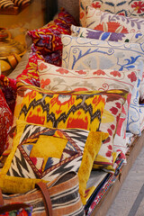 Fototapeta na wymiar Colourful cushions on display for sale in a traditional Turkish Bazaar.