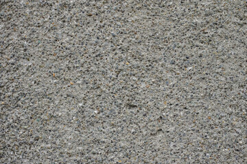 ざらざらした細かい砂利が混ざったコンクリートの表面のテクスチャー背景