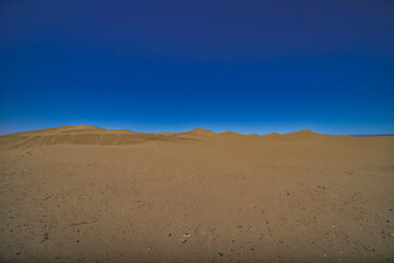 A panoramic sand dune of sahara desert at Mhamid el Ghizlane in Morocco wide shot
