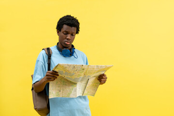 Confused African American Man With Map On Yellow Background, Travel, Direction, City, Exploration,...