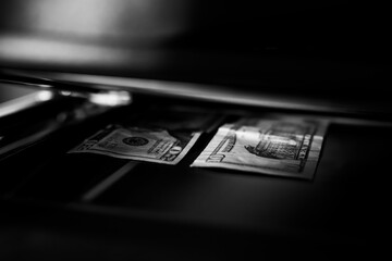 Using a copy machine to print forgery currency. 