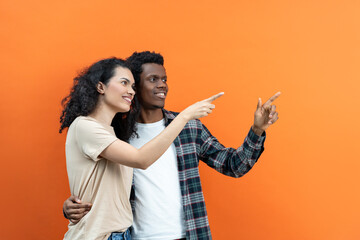 Happy Couple Pointing On Orange Background, Young People, Diversity, Smiling, Casual Clothing,...
