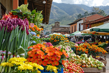 A vibrant market square with bustling stalls selling fresh produce flowers - obrazy, fototapety, plakaty