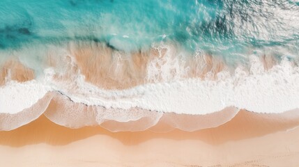 aerial view of the sea waves background rolling onto a pristine sandy beach, capturing the natural...