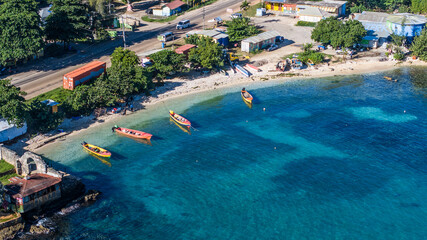 aerial landscape view of Old Folly at Discovery Bay, Jamaica with colorful boats typical of Jamaica on the small sand beach