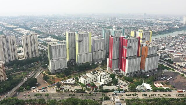 Jakarta Aerial View of Modern High-Rise Buildings by the Waterway in an Urban Metropolis at Midday, Wisma Atlet for Covid