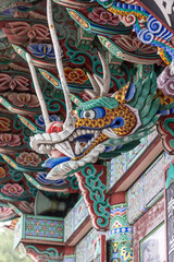 Obraz premium Closeup of wooden dragon carving with colorful Dancheong painting, Busan city, South Korea - April, 2017