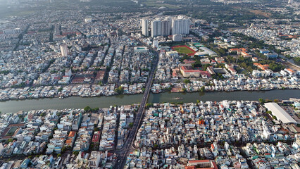 Amazing Aerial view of big Asian city, Ho Chi Minh scene, crowded riverside townhouse with dense...