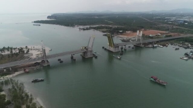 Aerial View of a Cable-Stayed Bridge Under Construction Near a Coastal Area at Dusk Bangka Belitung