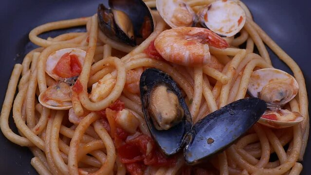Spaghetti allo scoglio, spaghetti with seafood. Italian pasta with mussels, shrimps and clams.