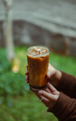 Kopi susu gula aren Person Holding Drink in Hand, Refreshment in Hand, Simple and Elegant