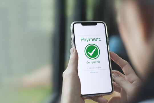 Payment complete Notifications. Customer using online banking application on smartphone to pay for purchases online and product in department store