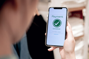 Payment complete Notifications. Customer using online banking application on smartphone to pay for purchases online and product in department store