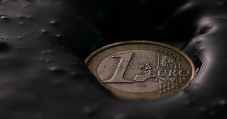 Euro Coin Submerged in Oil. Close-up, shallow dof.