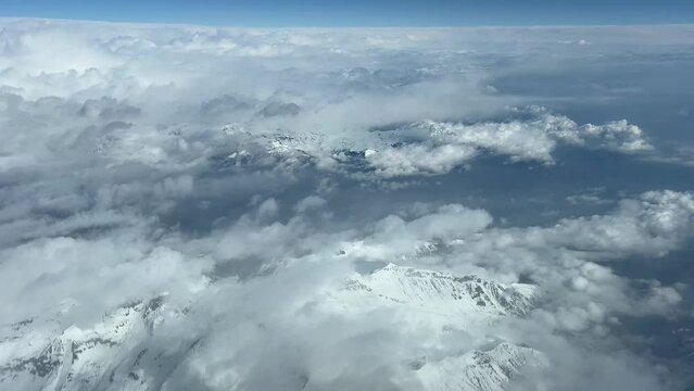 POV of The Alps Mountains with the snowed peaks, shot from an airplane cockpit in a real time flight bound Turin Airport. 4K