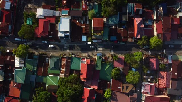 Top down drone shot above traffic on the streets of sunny San Pablo, Laguna, Philippines