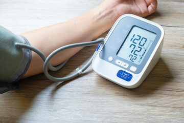 Man check blood pressure monitor and heart rate monitor with digital pressure gauge. Health care and Medical concept	
