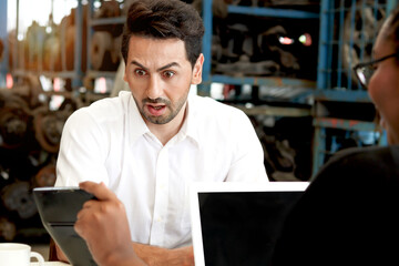 Unhappy man feel shocked and surprised by employee description prices of services and products in...