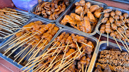 Various types of food and satay menus sold at Angkringan or street food carts in Yogyakarta, Indonesia.