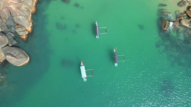 Aerial view of beautiful crystal clear water with boats in Butterfly beach Goa India 4K Drone