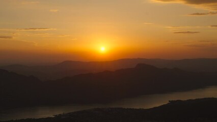 Sunset Aerial Drone Hyperlapse at Lake Bourget france aix les bains natural sky gradient turning into dusk at mountain background golden skyline