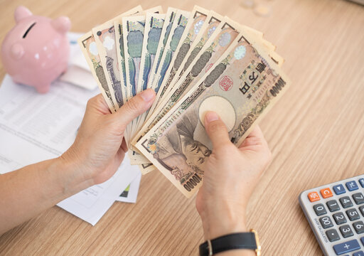 Japanese yen money on hand. concept of personal loan,home finance,income,savings.
