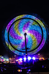 Carnival lights at night - The fun of summertime carnival and fair rides at night with colorful...