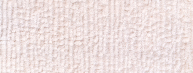 White fluffy background of soft, fleecy cloth. Texture of cream pastel textile backdrop with...