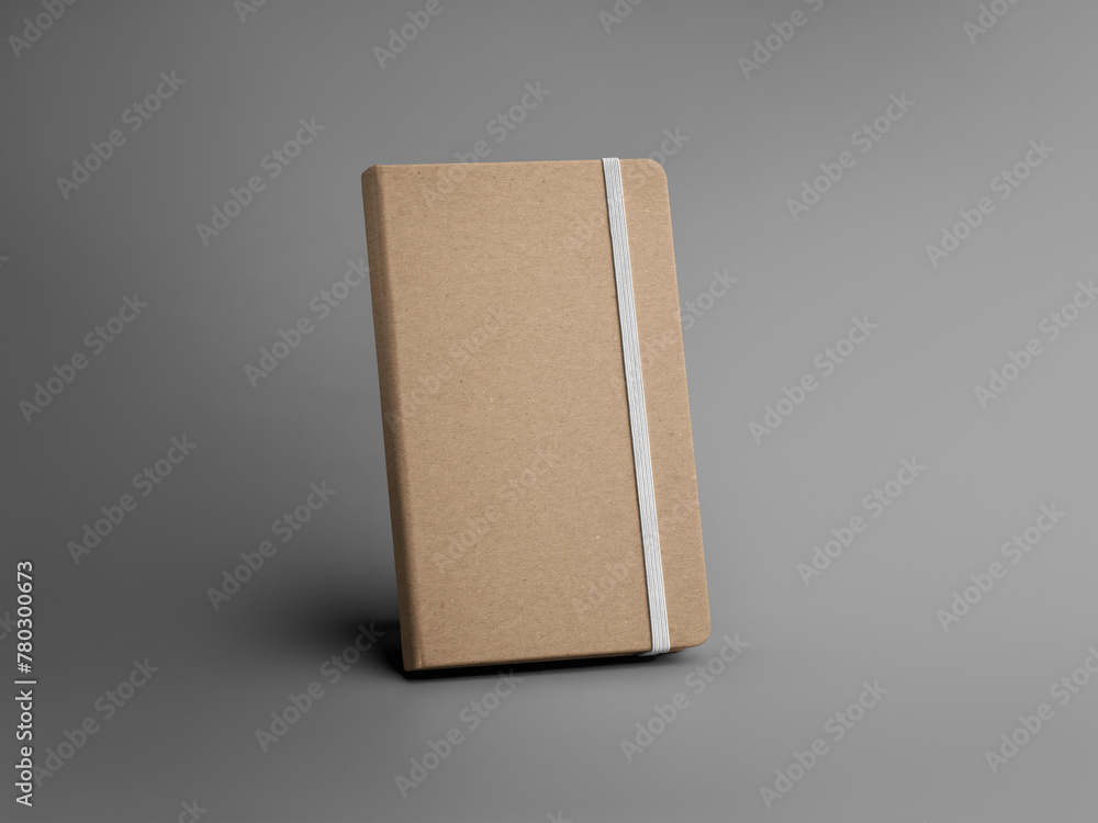 Poster a template of a closed craft notebook with a white band, standing on a gray background.