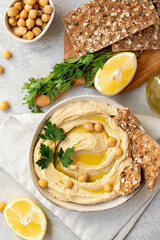 Traditional hummus with pita bread and paprika , lemon and olive oil