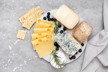 Italian and French gourmet Cheese platter with craft cheese assortment on a marble platter. hard...