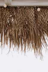 Thatching straw roof over bright sky view - 780305821