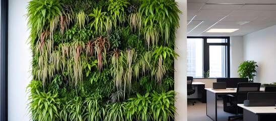 A green wall acts as a backdrop to an office space featuring a table and chairs, creating a vibrant and productive environment for work