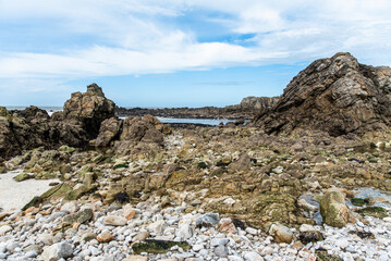Rocky ocean coast in Brittany, France at low tide.