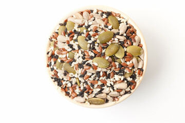 Fototapeta na wymiar Mixed seeds sunflower, black and white sesame, flax and pumpkin in bowl on white background. Top view