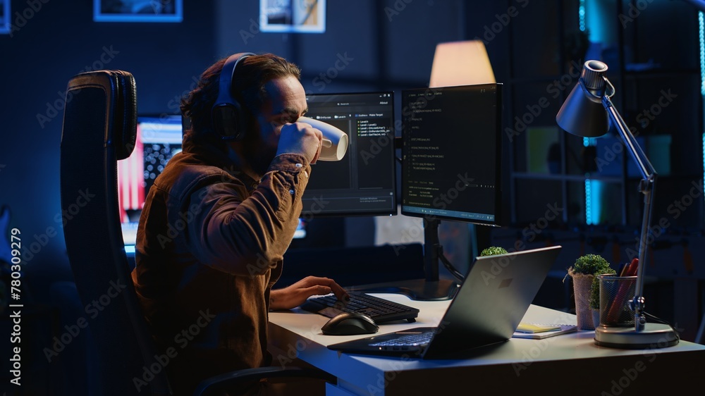 Poster programmer does multitasking to finish developing pc code, drinks coffee, listens music. it admin we