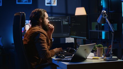 Developer typing code in home office, using Java programming language to develop software...
