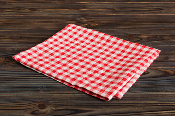 Obraz premium top view with red empty kitchen napkin isolated on table background. Folded cloth for mockup with copy space, Flat lay. Minimal style