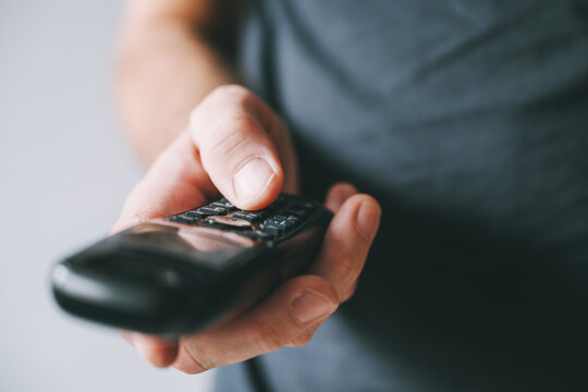Dialing cordless landline telephone device, closeup of male hand