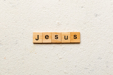 Jesus word written on wood block. Jesus text on table, concept