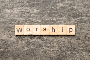 Fototapeta premium Worship word written on wood block. Worship text on cement table for your desing, concept
