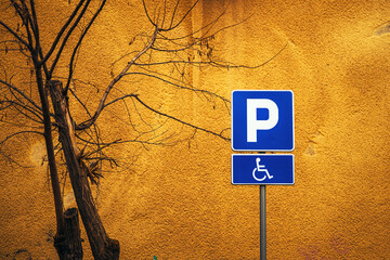 Accessible parking space sign against vibrant yellow wall