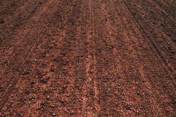 Texture of brown agricultural soil ready for tillage