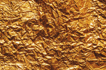 Background of golden wrapping paper crumpled and creased as texture - 780314876