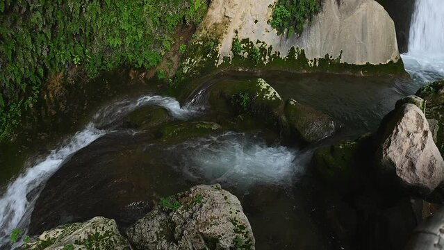 Steadicam shot of mountain stream in the forest. View from above of waterfall water flowing over rocks. Water cave in the village of Tiscar in the province of Jaen in Andalusia, Spain. Cueva del Agua