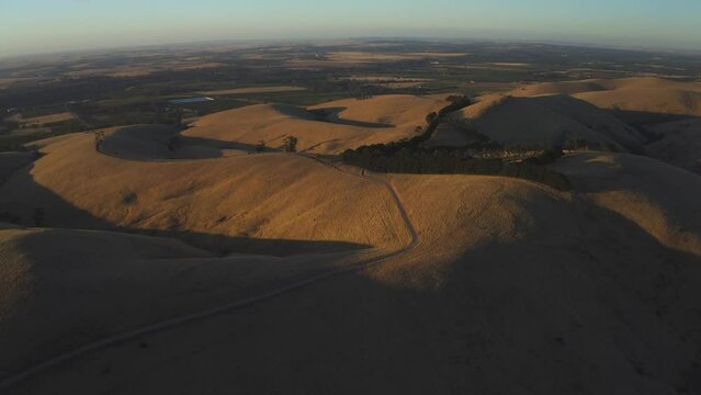 Aerial drone view at sunset of Steingarten lookout in South Australia.
Steingarten lookout, located in the Barossa Valley,  is the perfect spot for a picnic and a well-deserved glass of wine at sunset