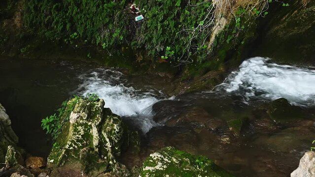 Mountain stream in the forest. Top view of the waterfall water flowing over rocks. Water cave in the village of Tiscar in the province of Jaen in Andalusia, Spain. Cueva del Agua