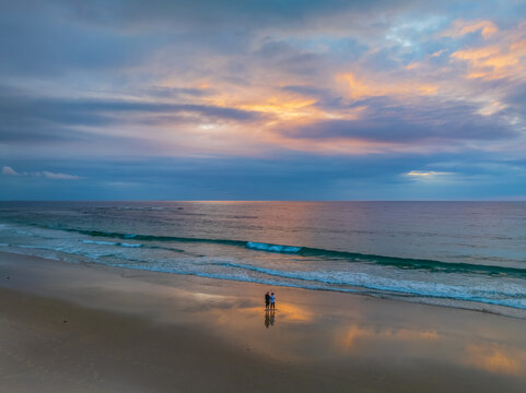 Sunrise Seascape with beautiful cloud covered sky and gentle surf